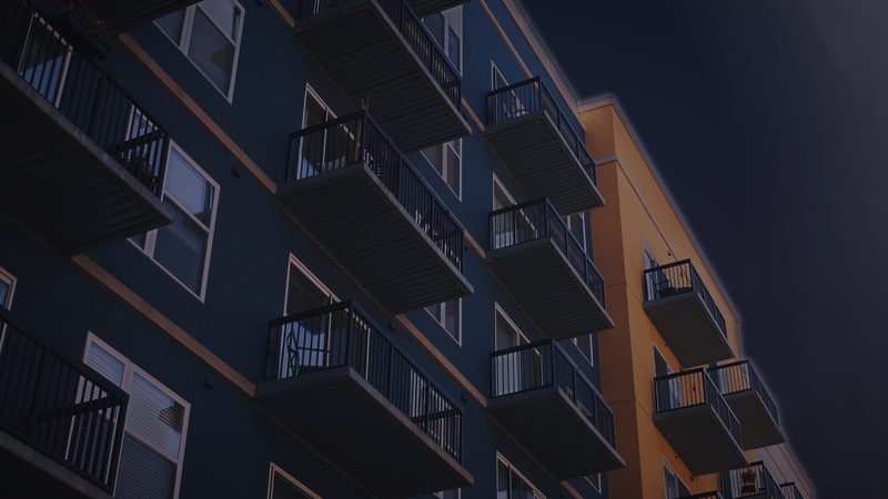 Apartment building with balconies at dusk